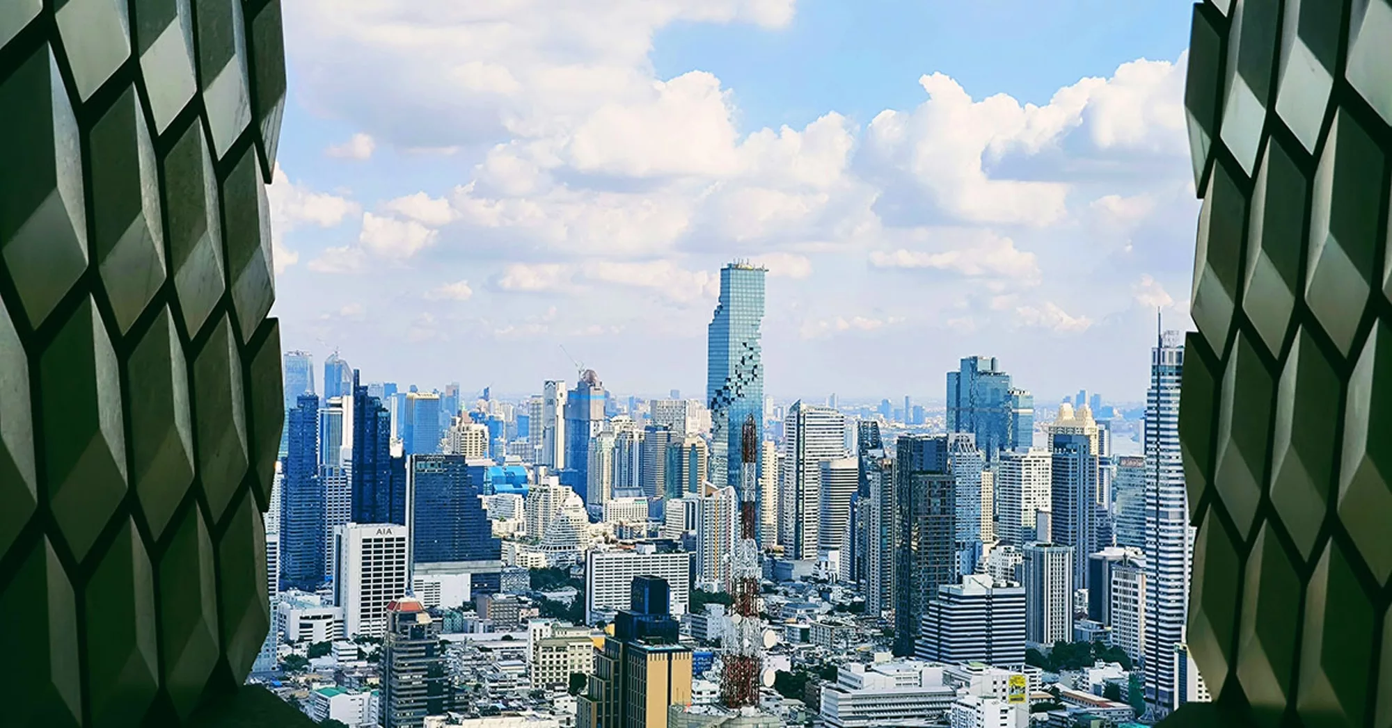 Cityscape view of modern skyscrapers framed by architectural patterns.