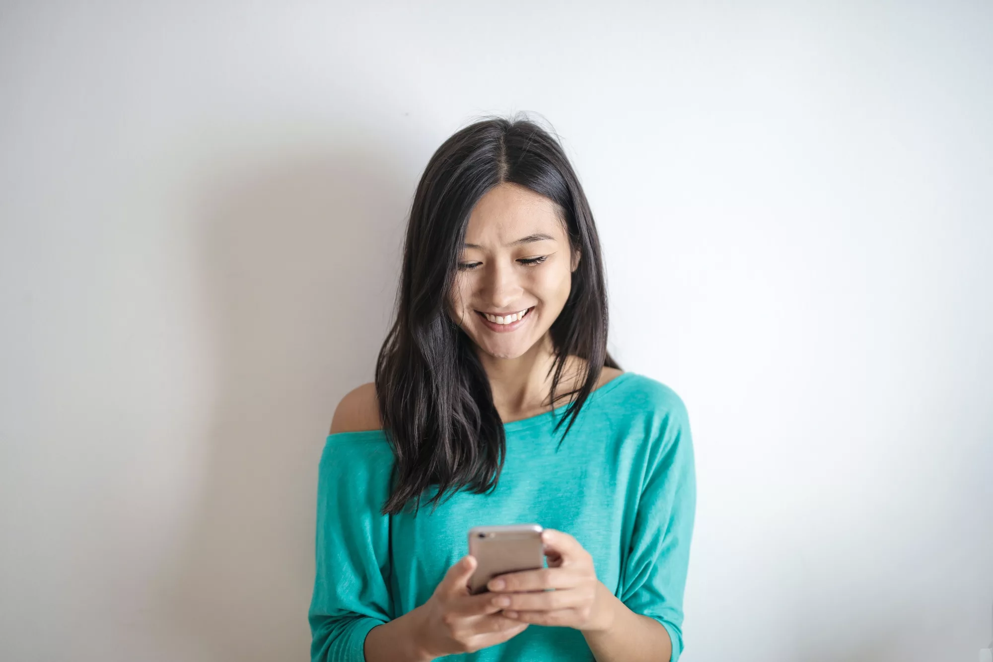 Smiling woman looking at her smartphone.