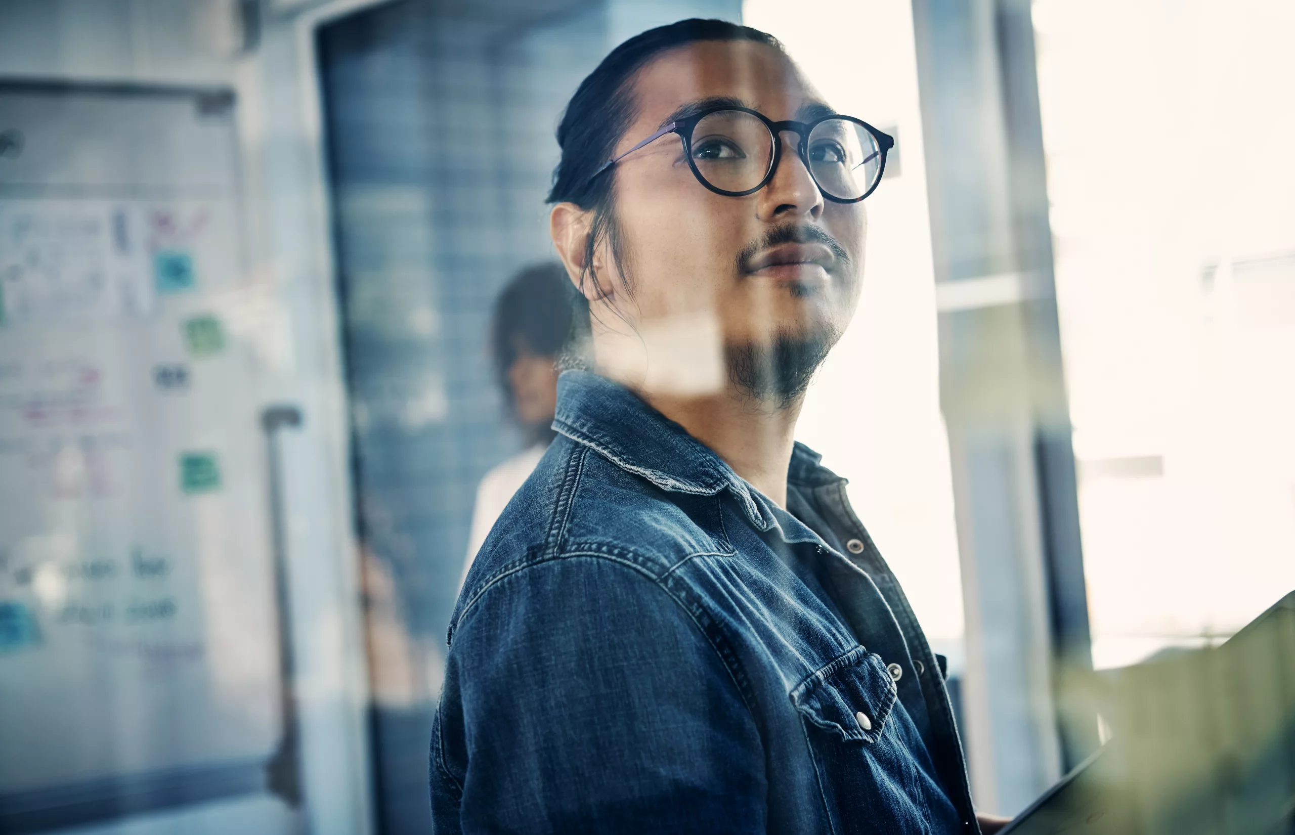 Programmer assigned to fix bugs looking through a glass window