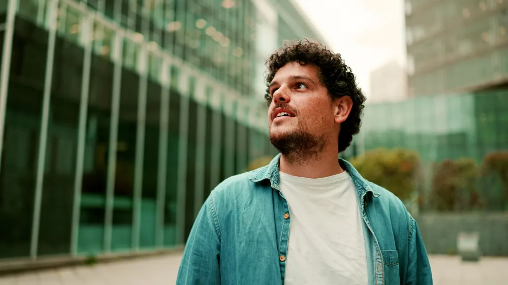 Man smiling outside office building